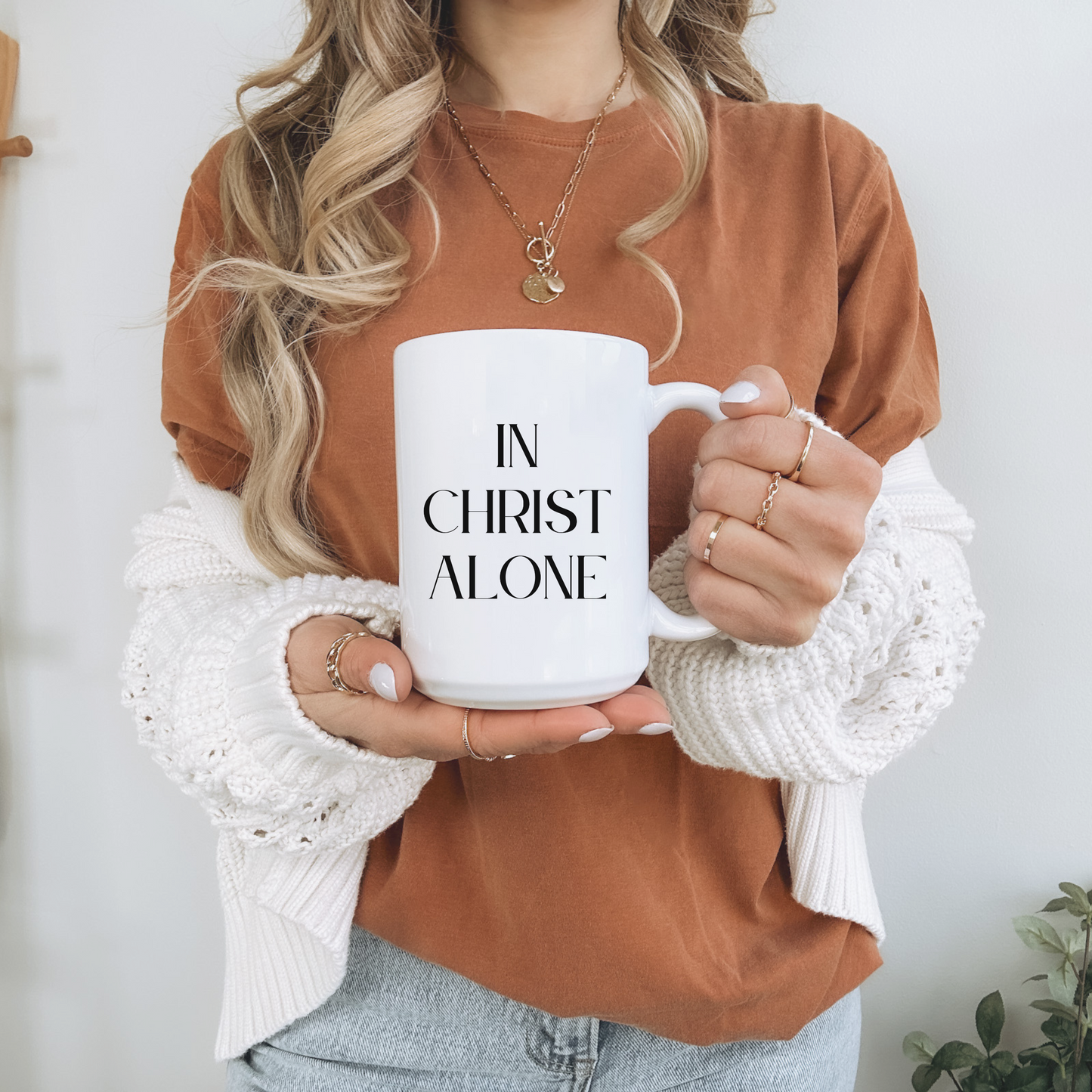 Large 15oz white Christian mug with bold black text reading "In Christ Alone". Scripture-inspired coffee mug for daily use.