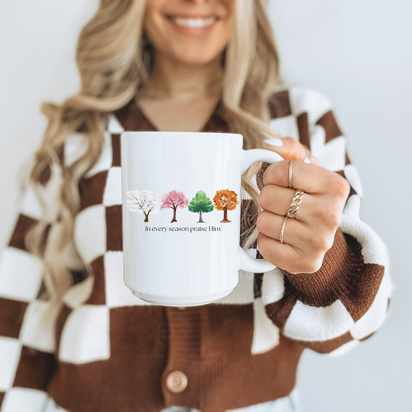 White 15oz Christian mug with tree design and text "In every season praise Him." Inspired by Psalm 34:1.