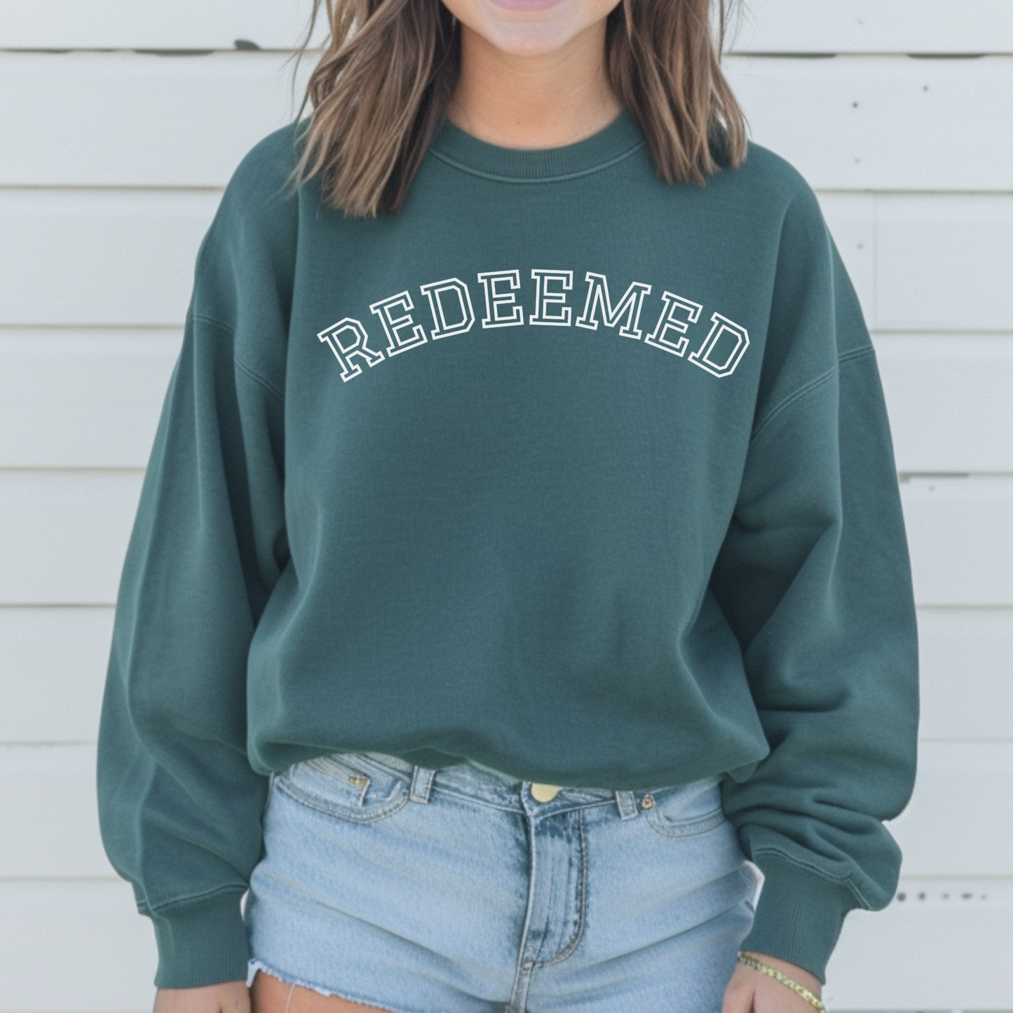 Faith Based Sweatshirt with text "Redeemed". Religious gift idea for anyone.