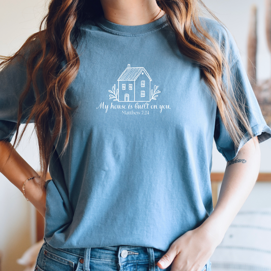 Christian t-shirt with simple house graphic and text "My House Is Built on You". Inspired by Matthew 7:24. Faith-based graphic tee. 