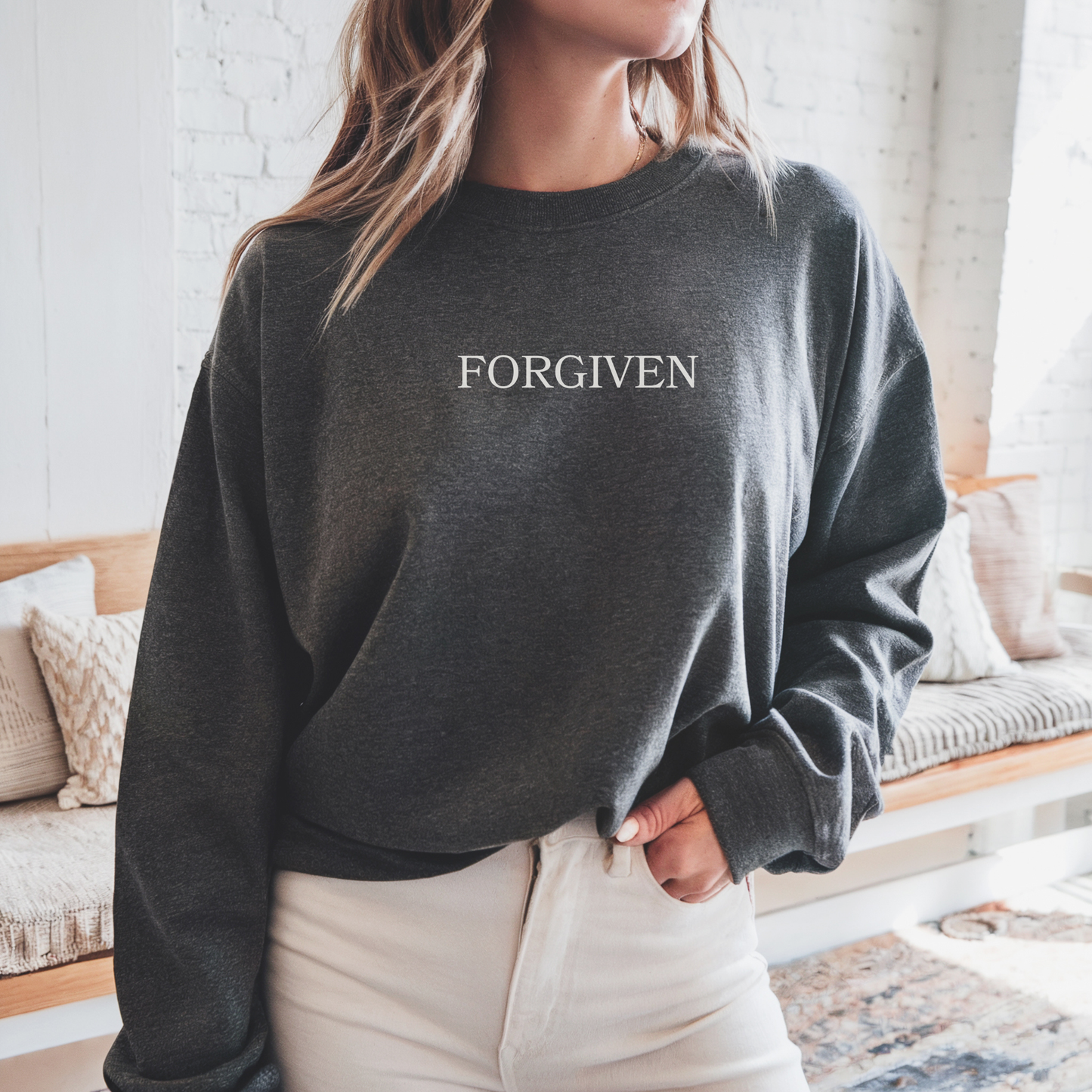 Minimalist sweatshirt with embroidered "FORGIVEN" inspired by Ephesians 4:32 and 1 John 1:9.