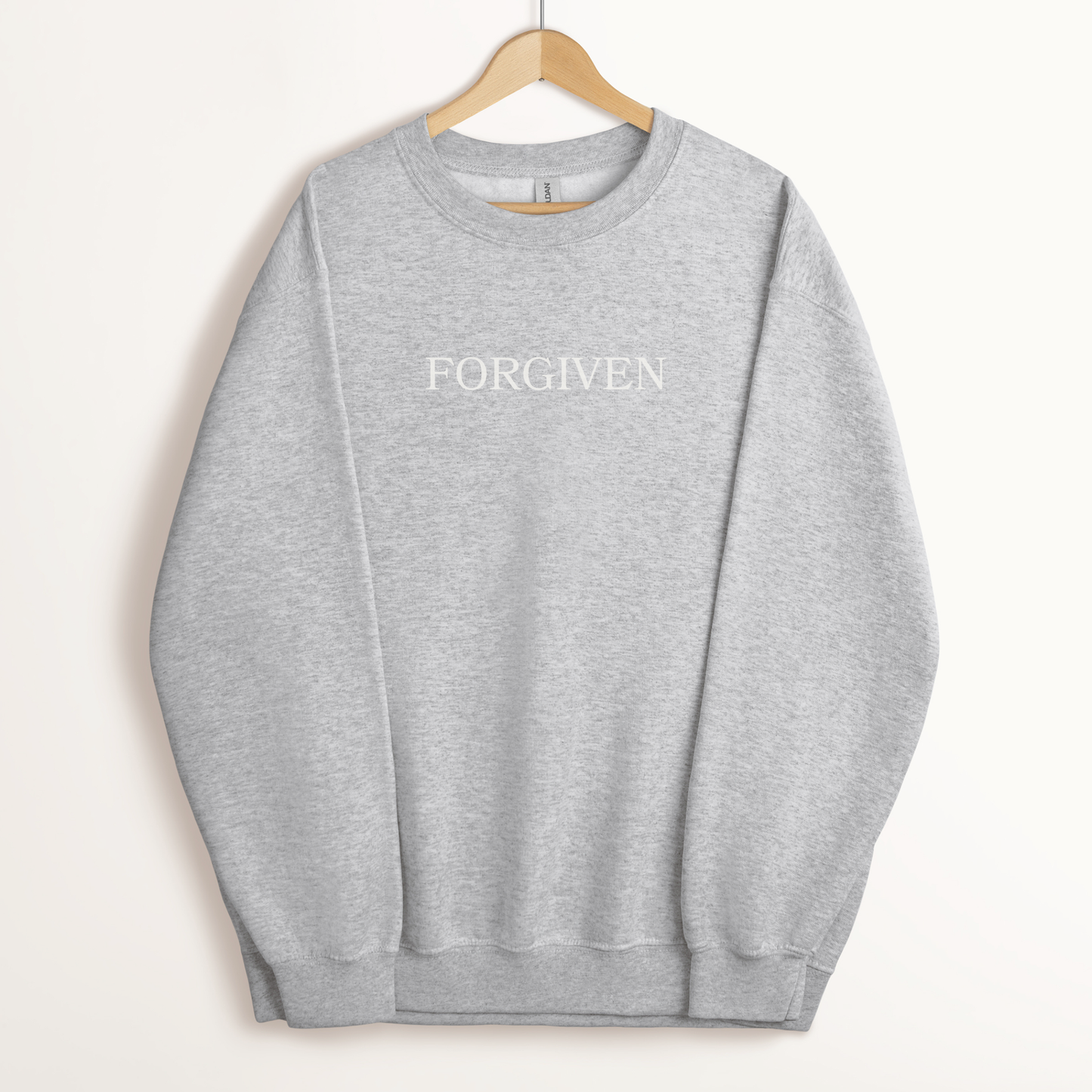 Neutral embroidered faith-based  crewneck displaying the word forgiven.