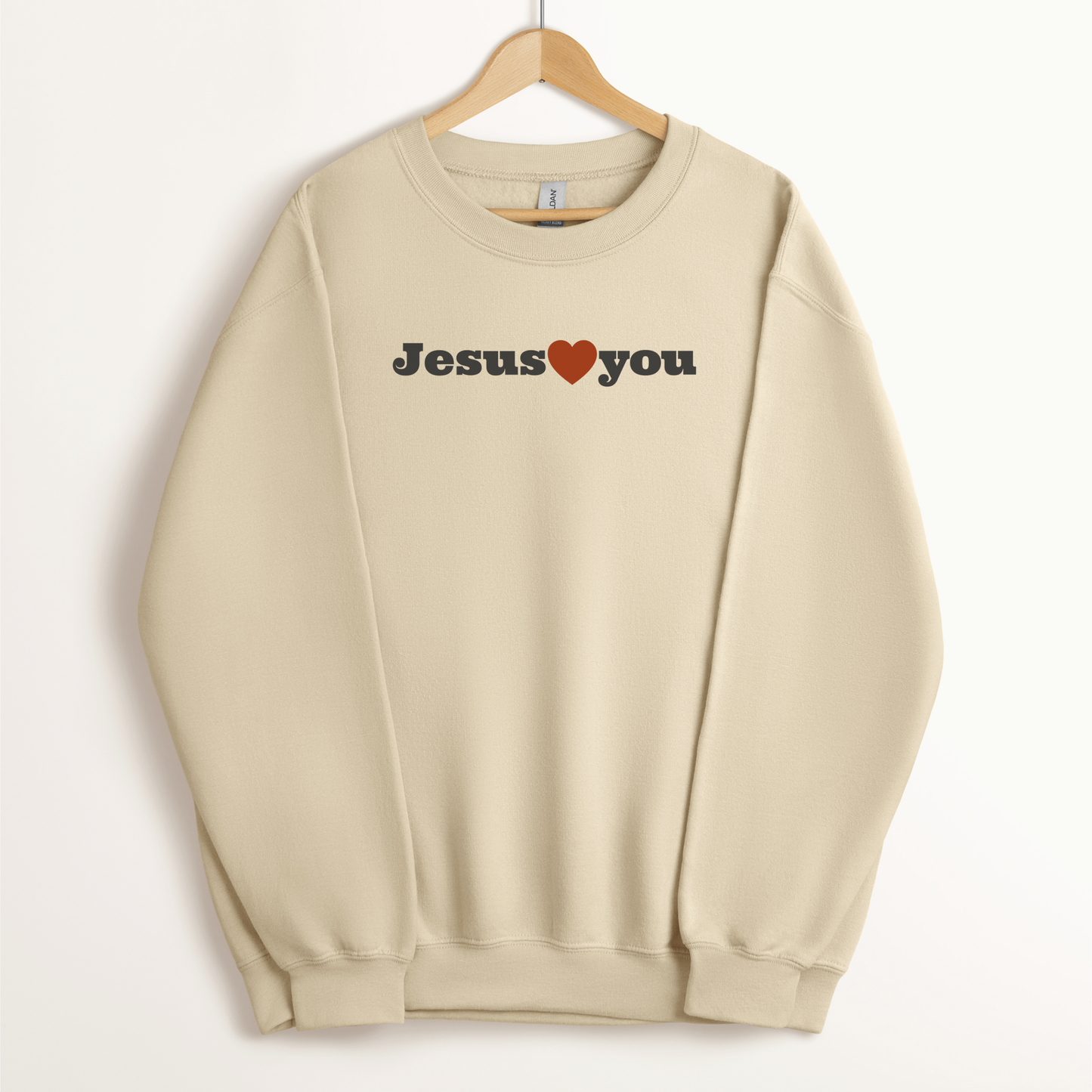 Christian sweatshirt from faith-based clothing company in neutral color that says "Jesus Loves You."