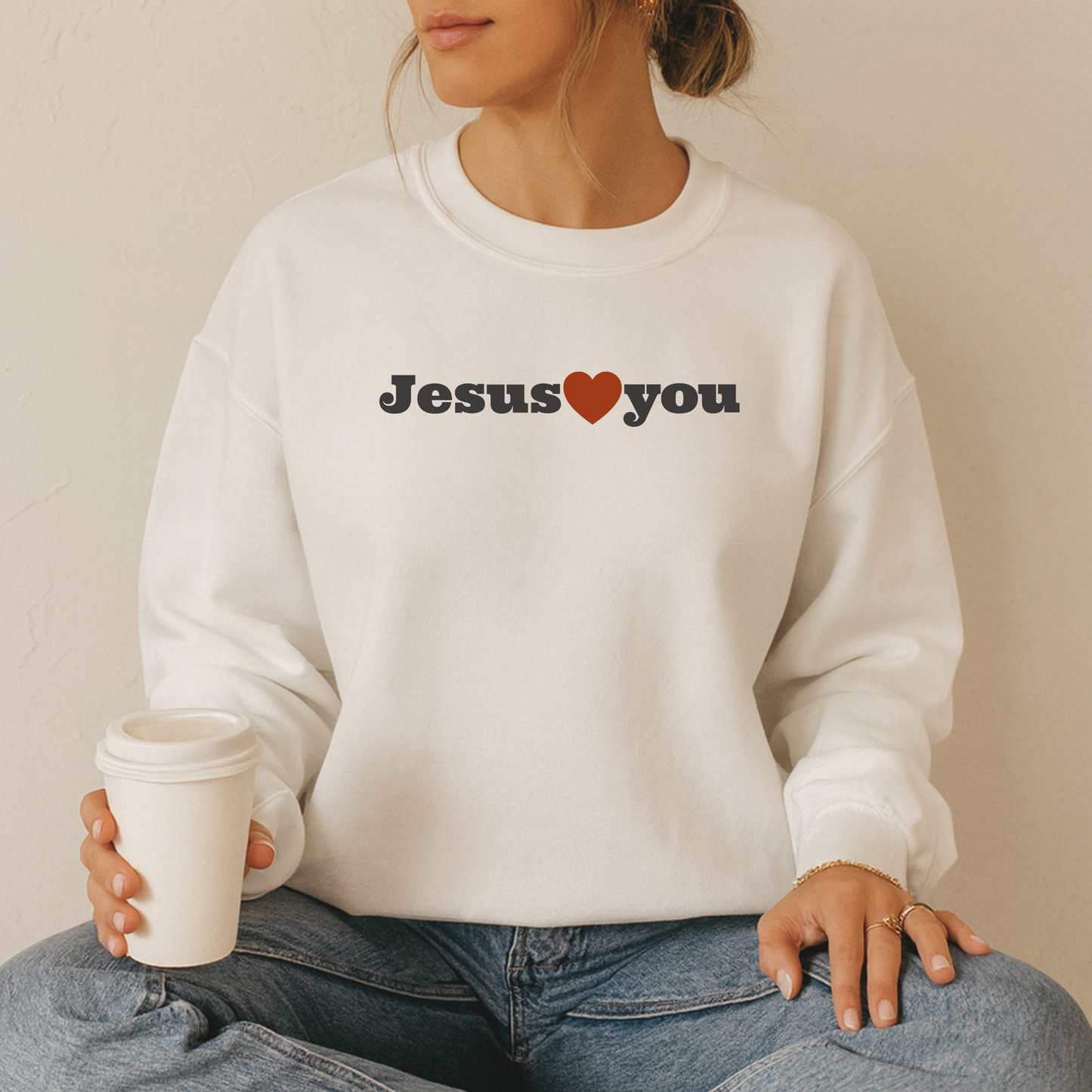 Faith-based sweatshirt in minimalist style reminding wearers that Jesus loves them. 