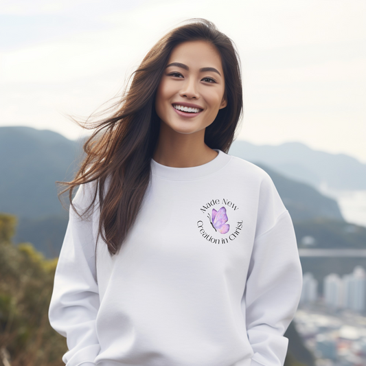 White Christian Sweatshirt with 2 Corinthians 5:17 Bible verse and butterfly graphic. 