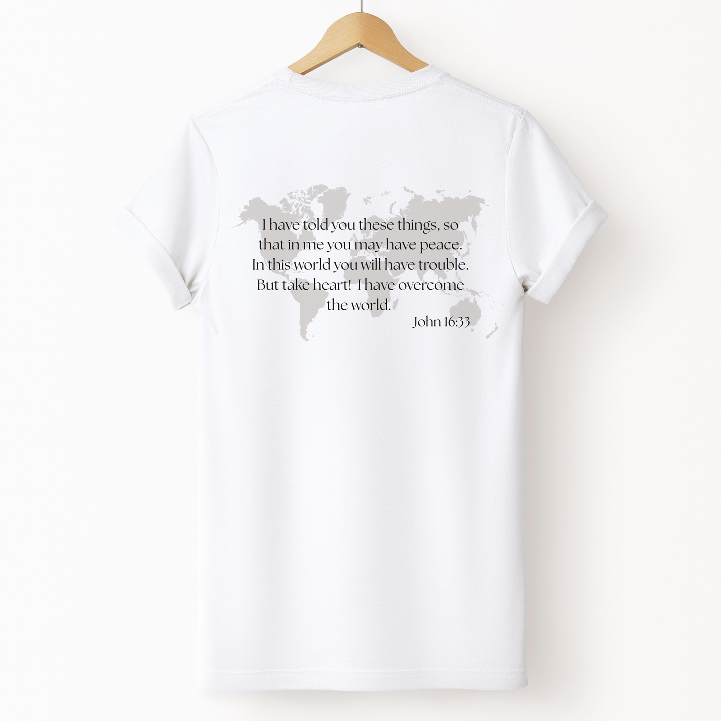 Bible verse T-shirt with world map graphic and encouraging scripture from John 16:33. 